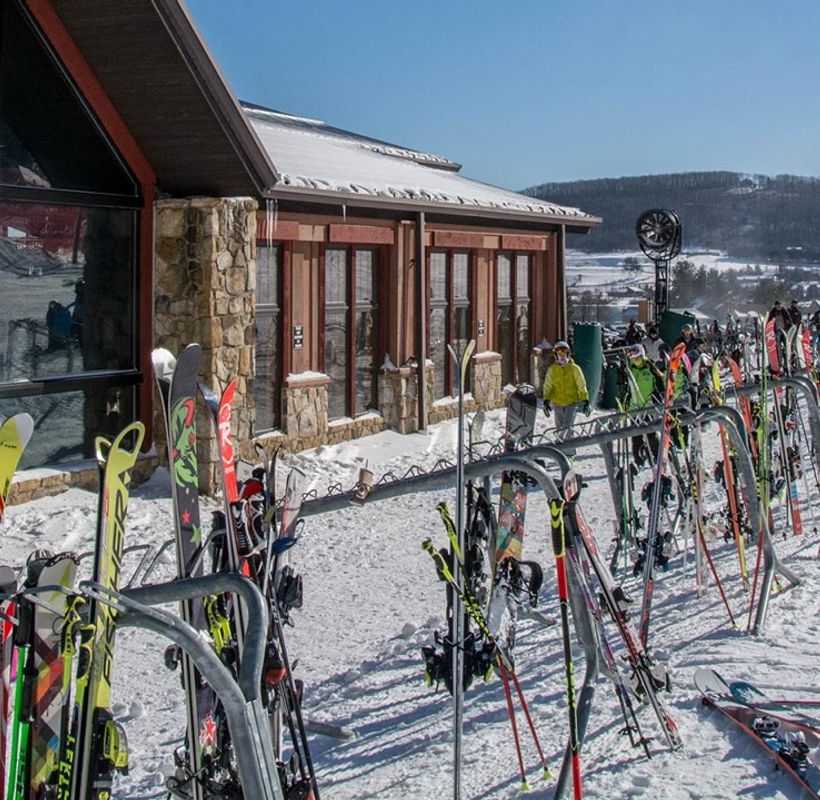 Skis lined up outside the lodge at Wisp Resort